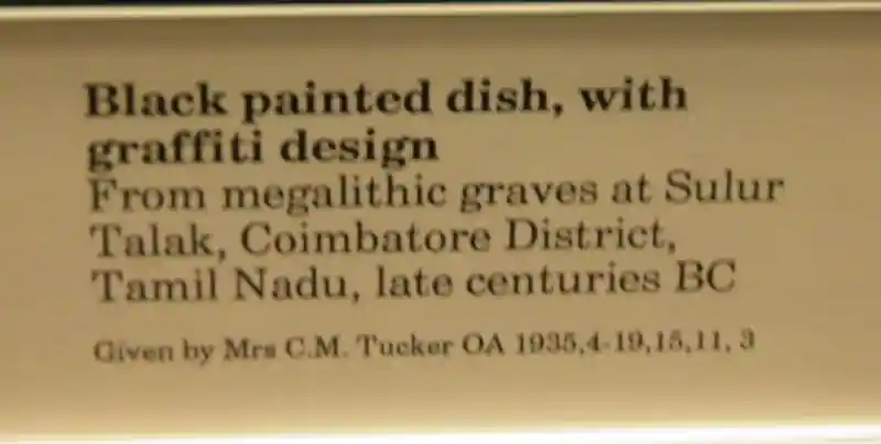 Cross on a black dish with graffiti design